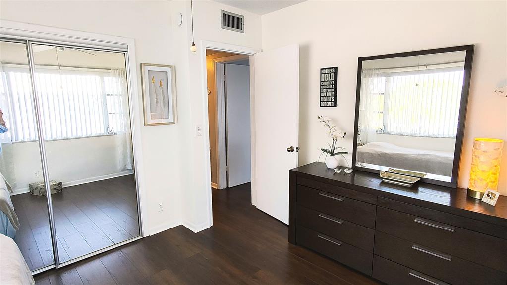 412 South Cypress Road, Unit 222 Pompano Beach, FL 33060 - Photo 13 of 19 a view of a mirror and a dresser