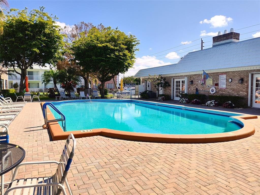 412 South Cypress Road, Unit 222 Pompano Beach, FL 33060 - Photo 16 of 19 a view of a swimming pool with a patio
