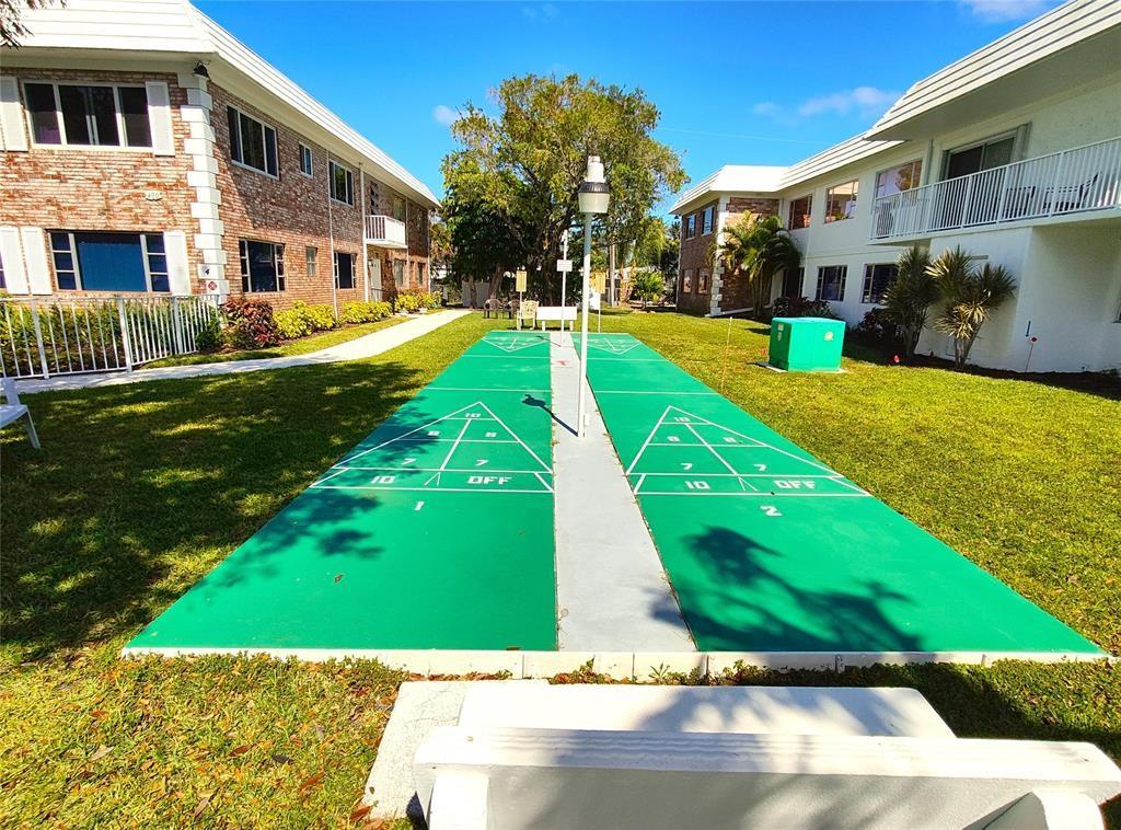 412 South Cypress Road, Unit 222 Pompano Beach, FL 33060 - Photo 18 of 19 a view of a building with a yard