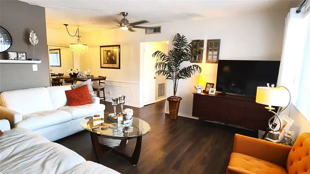 a living room with furniture fireplace and a potted plant