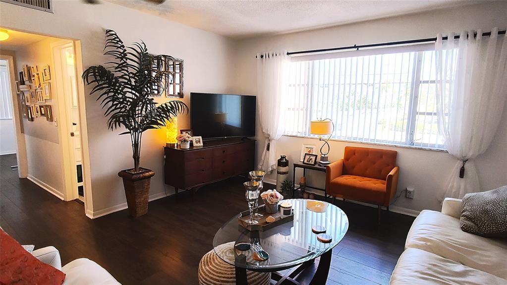 412 South Cypress Road, Unit 222 Pompano Beach, FL 33060 - Photo 4 of 19 a living room with furniture and a flat screen tv