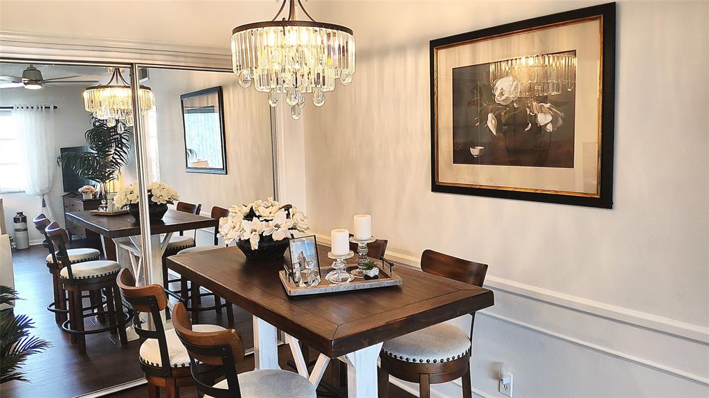412 South Cypress Road, Unit 222 Pompano Beach, FL 33060 - Photo 5 of 19 a view of a dining room with furniture wooden floor and chandelier