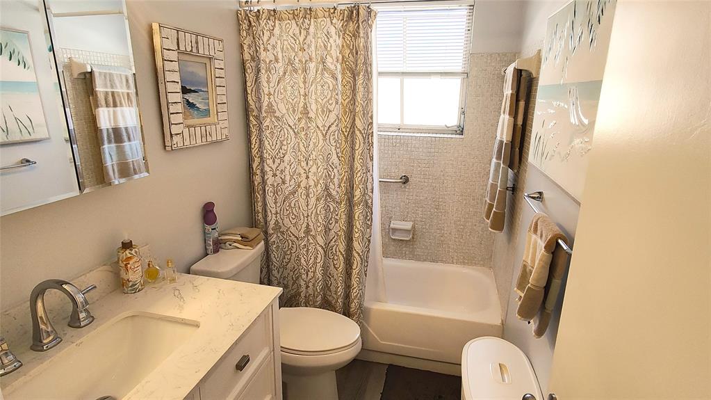 412 South Cypress Road, Unit 222 Pompano Beach, FL 33060 - Photo 6 of 19 a bathroom with a sink toilet and shower