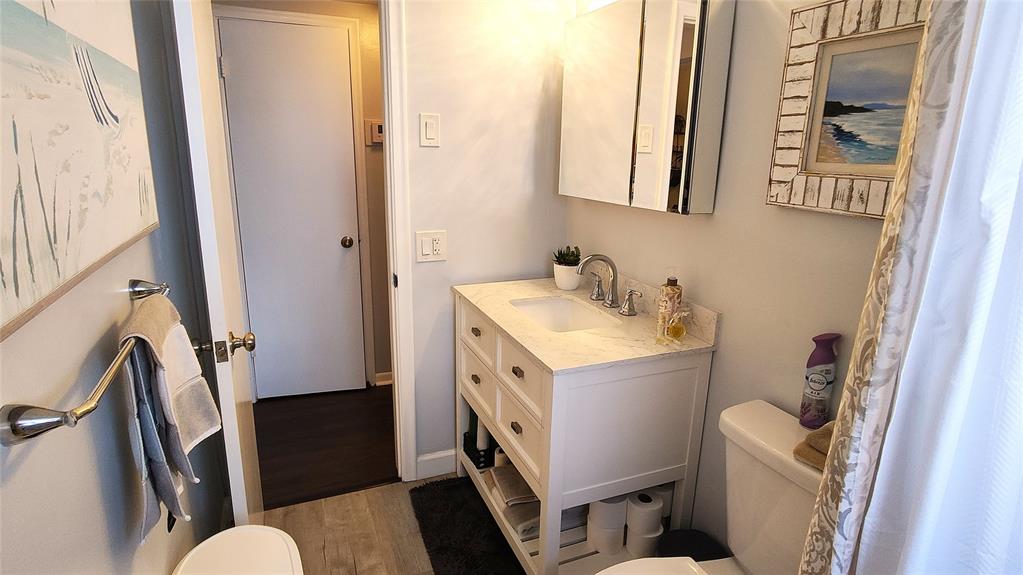 412 South Cypress Road, Unit 222 Pompano Beach, FL 33060 - Photo 7 of 19 a bathroom with a sink a toilet a mirror and a shower