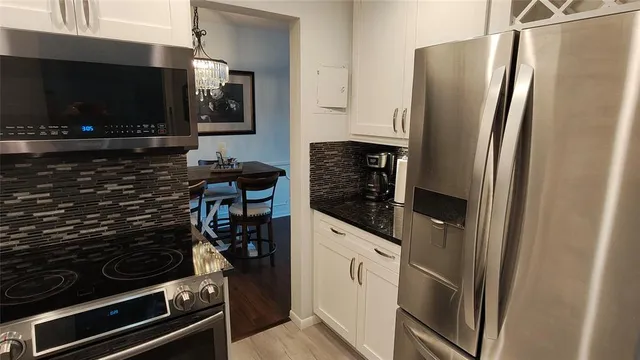 a kitchen with stainless steel appliances a refrigerator and a stove top oven