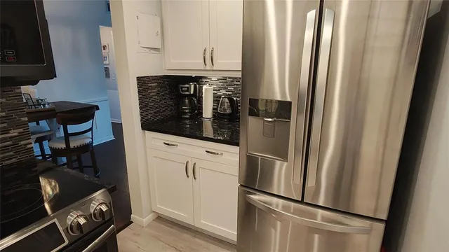 a kitchen with stainless steel appliances a refrigerator and cabinets
