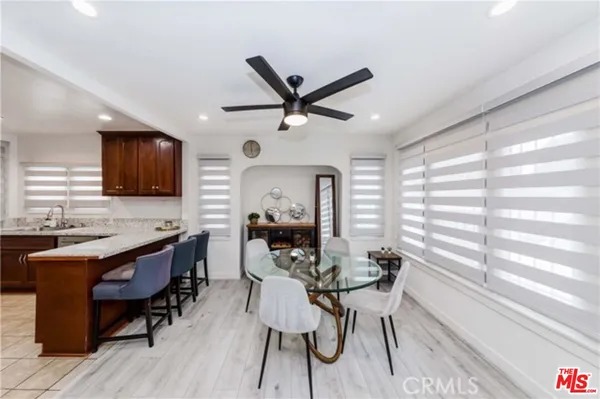 a view of a dining room with furniture window and wooden floor