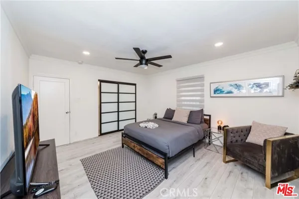 a living room with furniture a ceiling fan and a rug