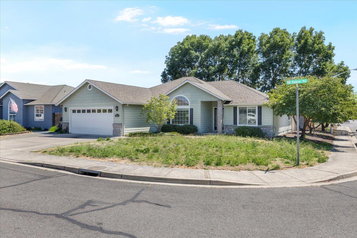 2308 Rabun Way Central Point, OR 97502 - Photo 1 of 26 a front view of a house with a garden