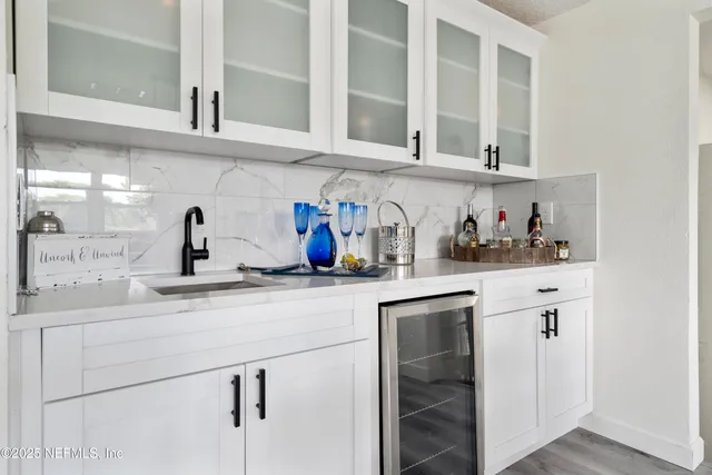 a kitchen with white cabinets stainless steel appliances and sink