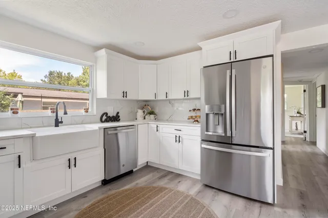 a kitchen with stainless steel appliances a stove a sink and a microwave