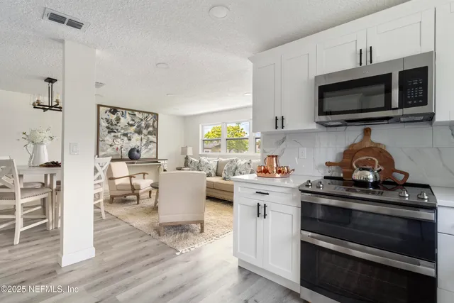 a dining room with furniture a rug and a large window