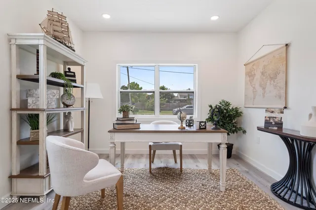 a bathroom with a glass shower door and a window