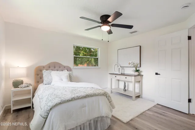 a bedroom with bed and a large window