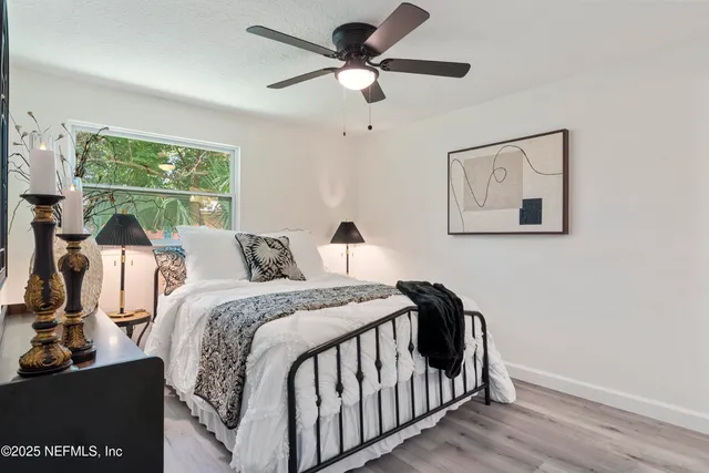 a bedroom with a bed and a chandelier