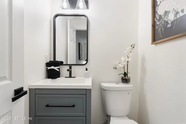 a view of house with backyard and a tree