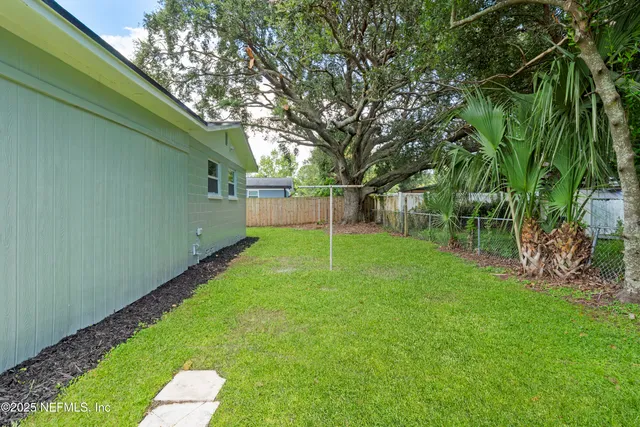 an aerial view of residential house with outdoor space and swimming pool