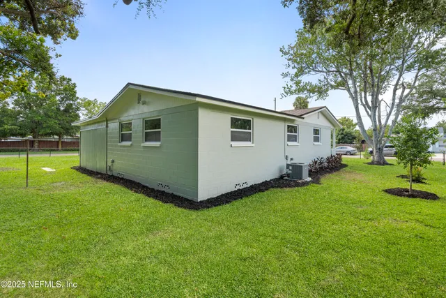 an aerial view of a residential houses with outdoor space and street view