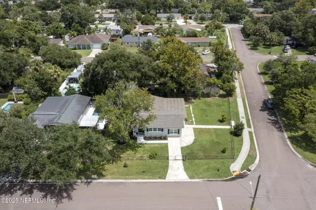 a view of a chair and tables of the patio in front of the house
