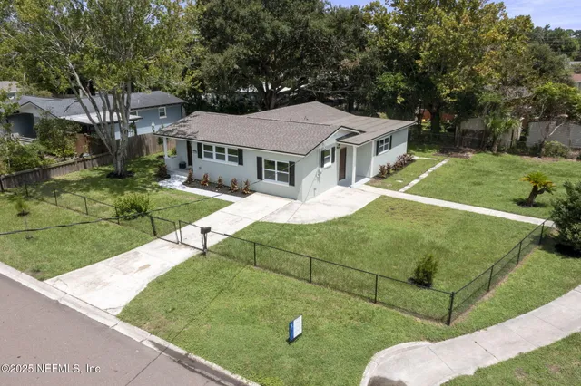 a view of a park with swings and a yard