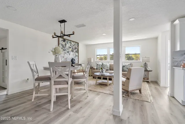 a living room with furniture and a painting on the wall