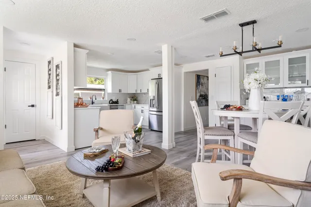 a kitchen with white cabinets and a sink