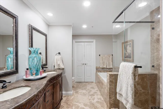 a bathroom with a double vanity sink a mirror and a shower