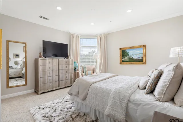 a bedroom with furniture and a flat screen tv
