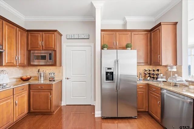 a kitchen with stainless steel appliances a refrigerator stove and sink