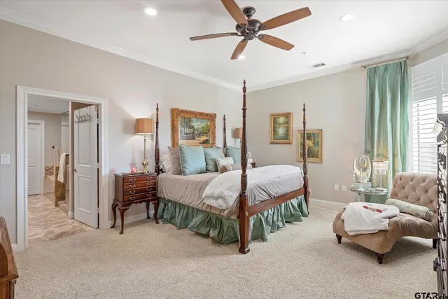 a spacious bedroom with a bed and a chandelier