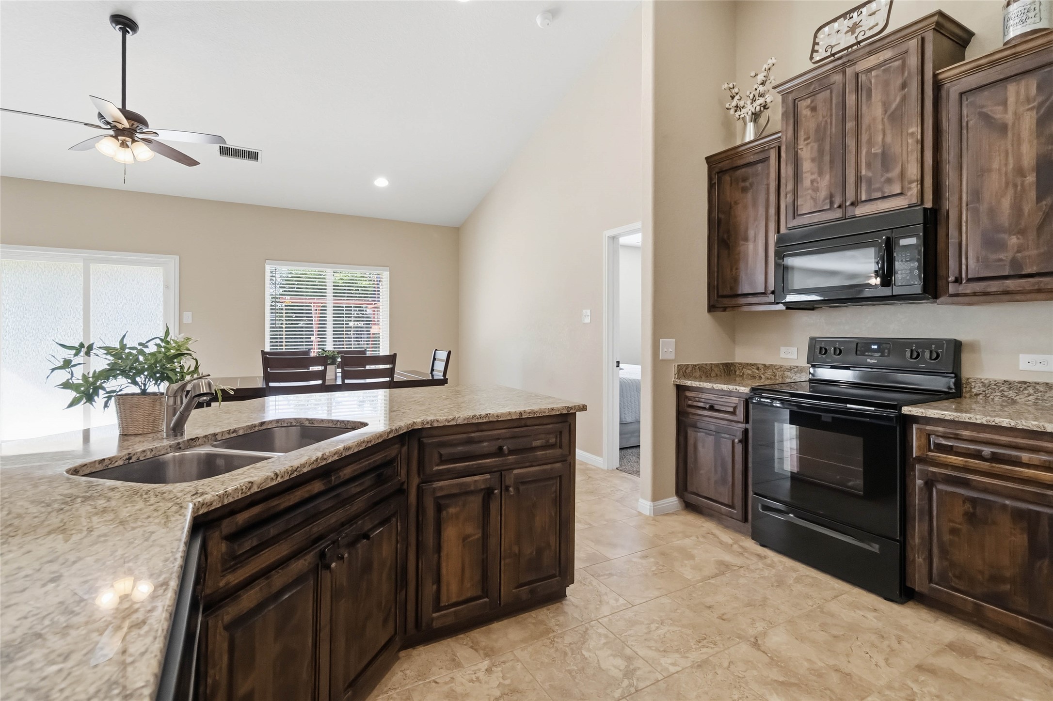 285 Hummingbird Way Martindale, TX 78655 - Photo 6 of 40 a kitchen with stainless steel appliances granite countertop a sink stove and microwave