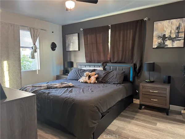 a bed sitting in a bedroom next to a window