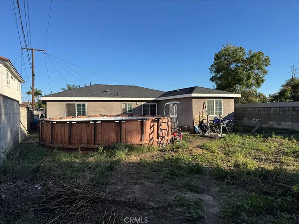 a view of a house with wooden fence