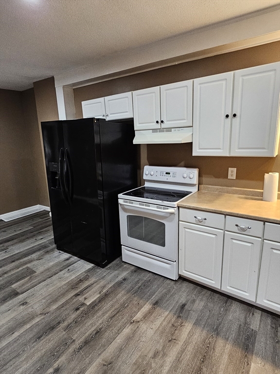 176 Corthell Street, Unit 1 Springfield, MA 01151 - Photo 14 of 28 a kitchen with a refrigerator and white cabinets