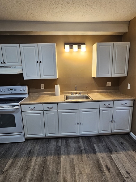176 Corthell Street, Unit 1 Springfield, MA 01151 - Photo 18 of 28 a kitchen with granite countertop cabinets stainless steel appliances a sink and a window