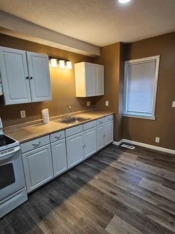 a kitchen with sink and cabinets