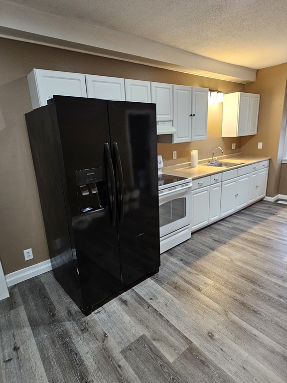 176 Corthell Street, Unit 1 Springfield, MA 01151 - Photo 26 of 28 a kitchen with a refrigerator and a stove