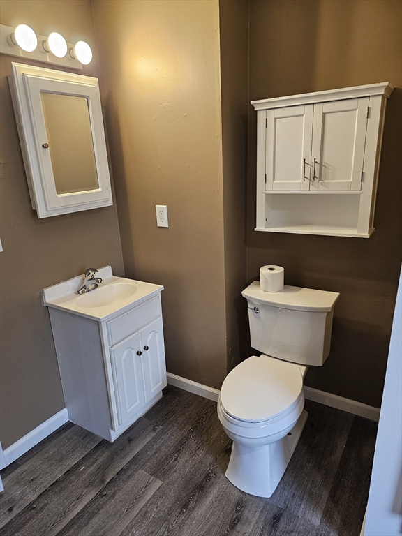 176 Corthell Street, Unit 1 Springfield, MA 01151 - Photo 5 of 28 a bathroom with a toilet sink and mirror