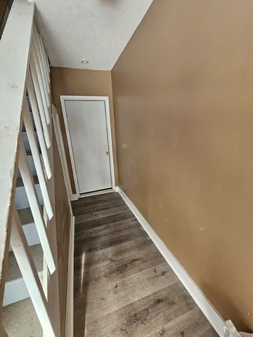 a view of staircase with wooden floor and stove