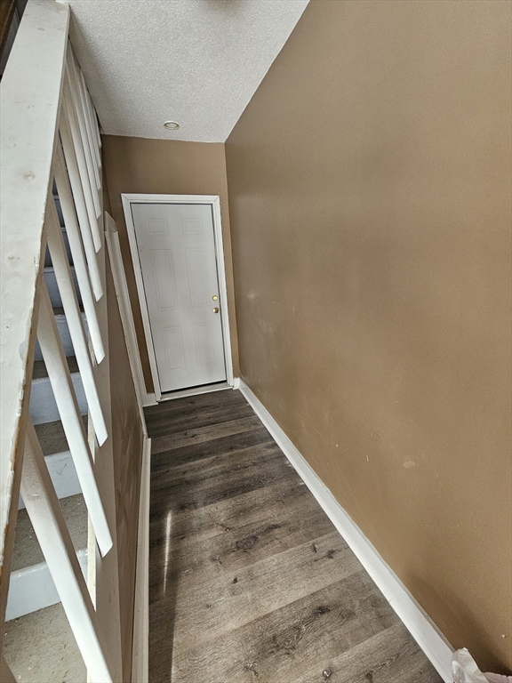 176 Corthell Street, Unit 1 Springfield, MA 01151 - Photo 7 of 28 a view of staircase with wooden floor and stove