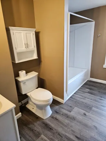 a white toilet sitting next to a bathroom sink