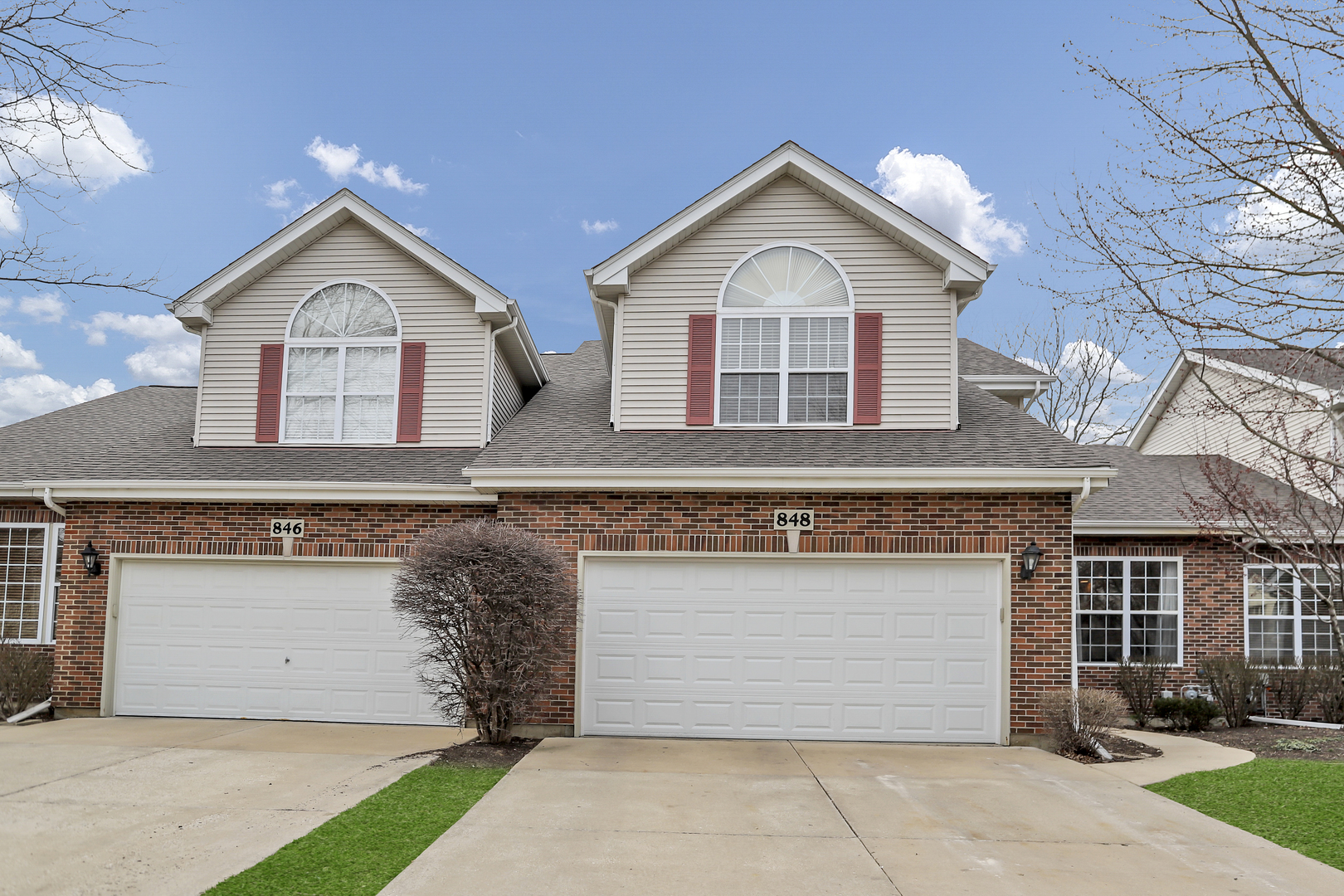 848 Pheasant Trail St. Charles, IL 60174 - Photo 2 of 30 a front view of a house with a yard and garage