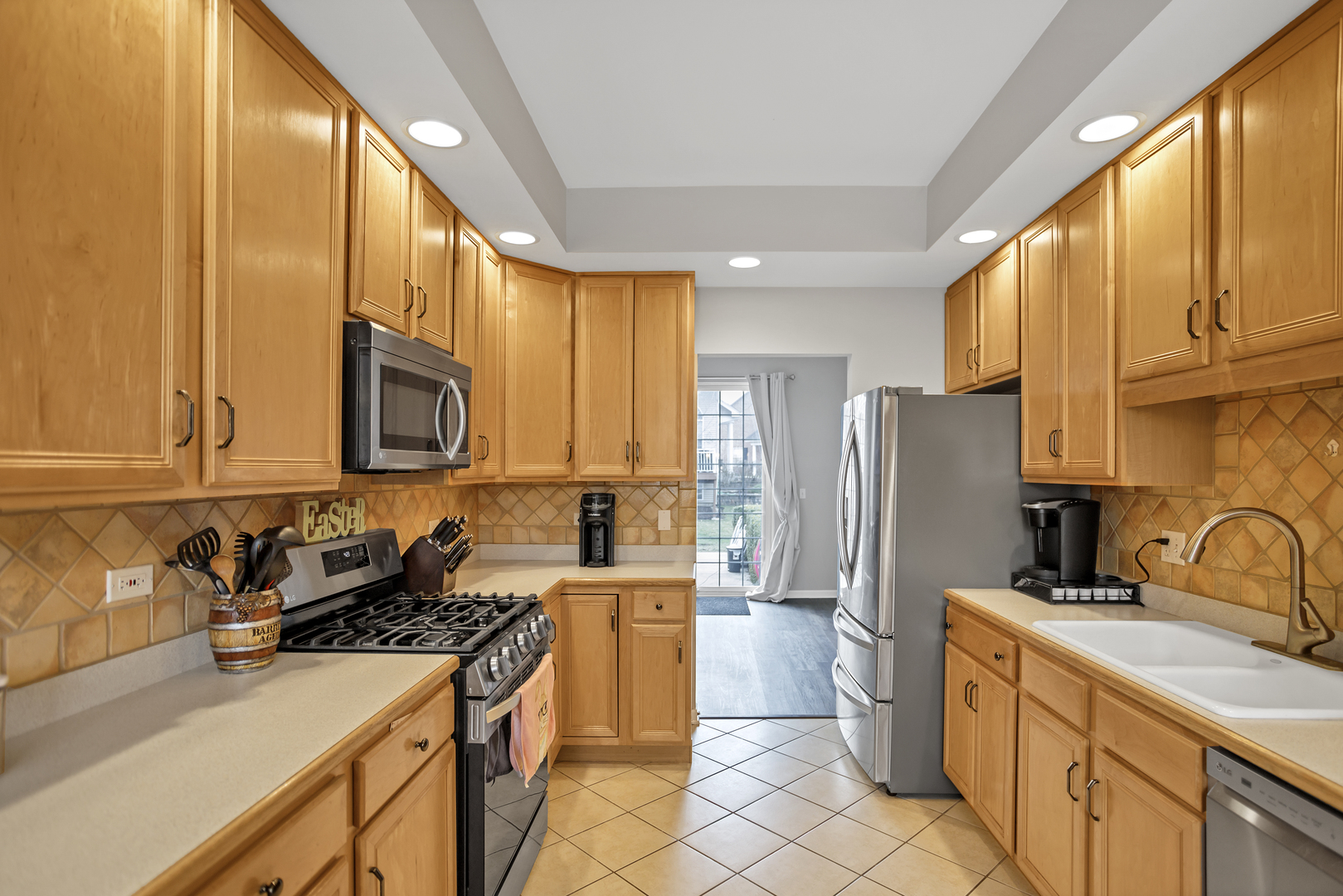 848 Pheasant Trail St. Charles, IL 60174 - Photo 10 of 30 a kitchen with a sink a refrigerator and cabinets