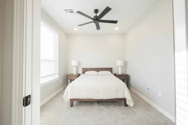 a bedroom with a bed and a large mirror
