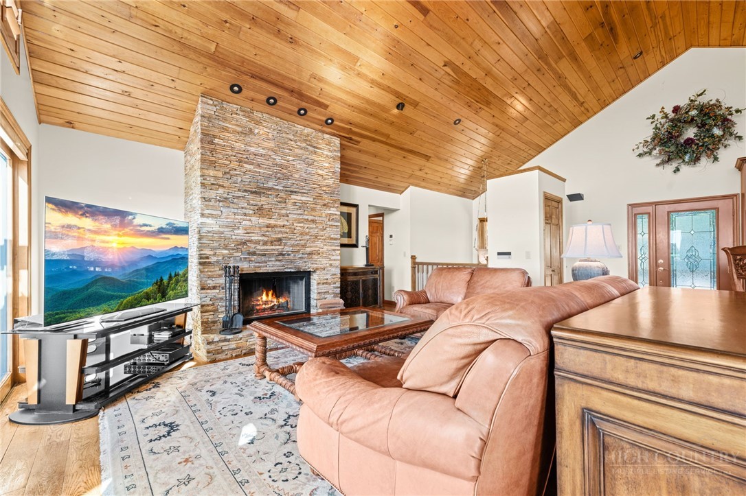 331 Alpine Road Blowing Rock, NC 28605 - Photo 13 of 50 a living room with furniture a flat screen tv and a fireplace