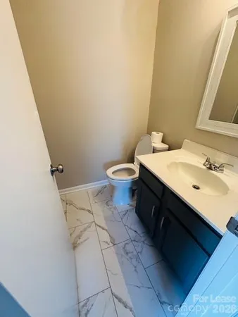 a bathroom with a sink toilet and vanity