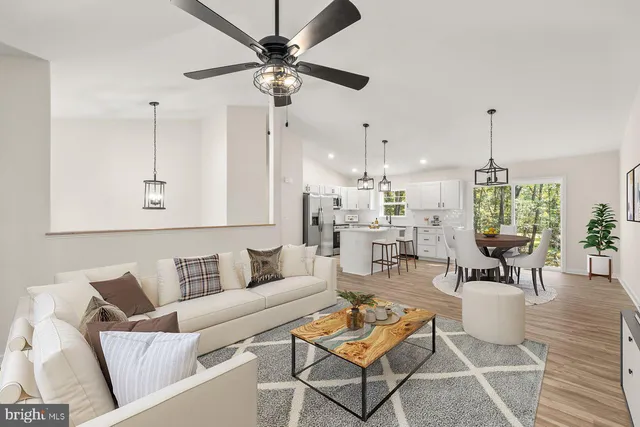 a living room with furniture and a chandelier