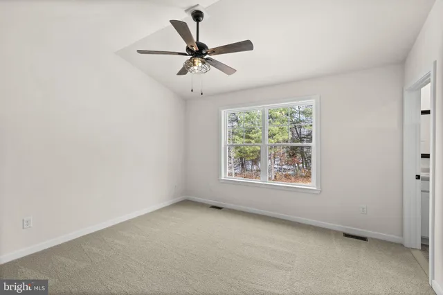a view of a livingroom with a ceiling fan & a ceiling fan