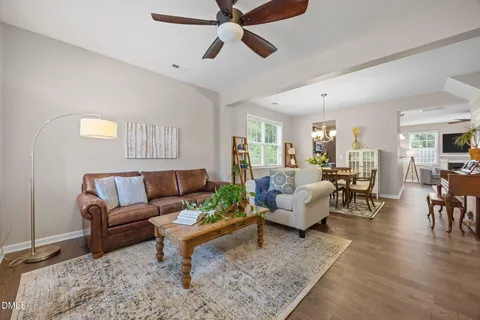 a living room with furniture and a view of kitchen
