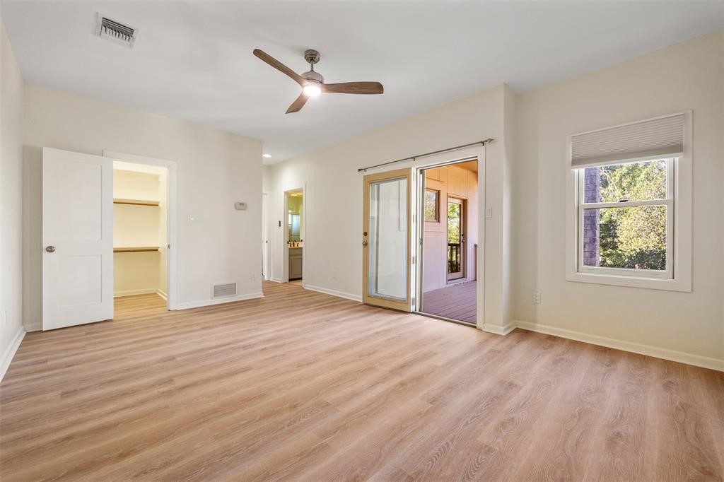 6 Sunview Road The Hills, TX 78738 - Photo 16 of 19 a view of an empty room with window and wooden floor